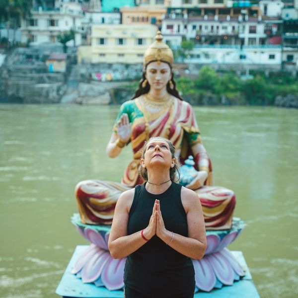 Person meditating peacefully outdoors with a soft focus background.